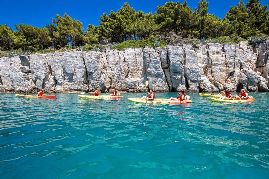 From Split: Sea Kayaking Tour - Kasjuni Beach break: swimming, snorkeling, and that cliff jump moment