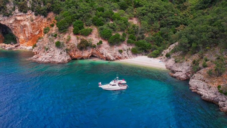 Opatija/Lovran: Boat Trip to Secluded Beaches on Island Cres - Brseč Beach: pebbles, cliff shade, and clear water first thing