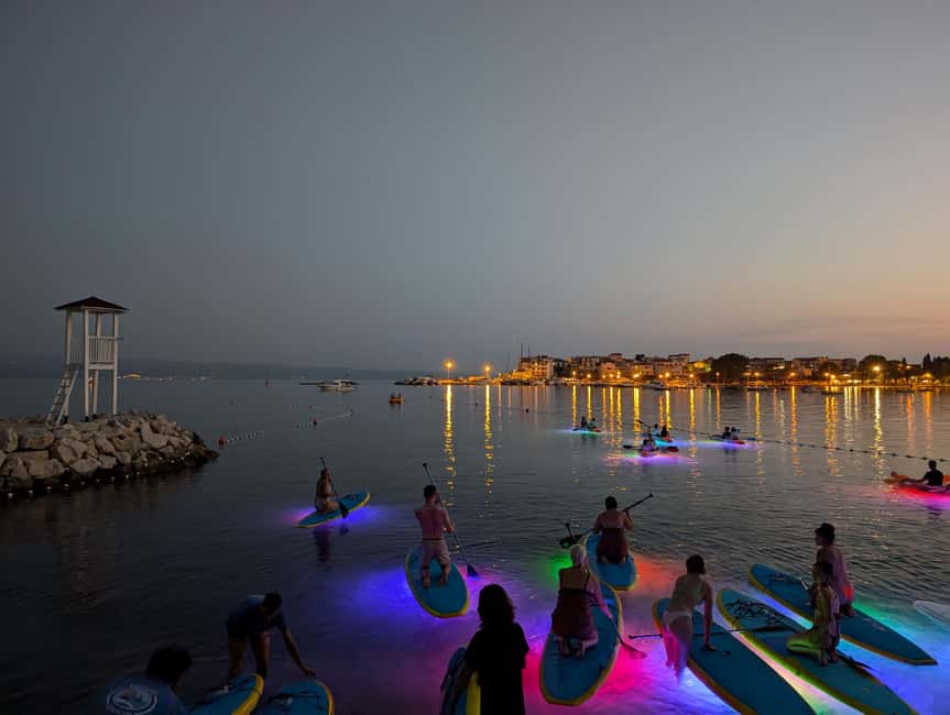 Split: Stand Up Paddleboard Night Glow Tour - The sea stretch at night: cliffs, white rocks, and that LED underwater map