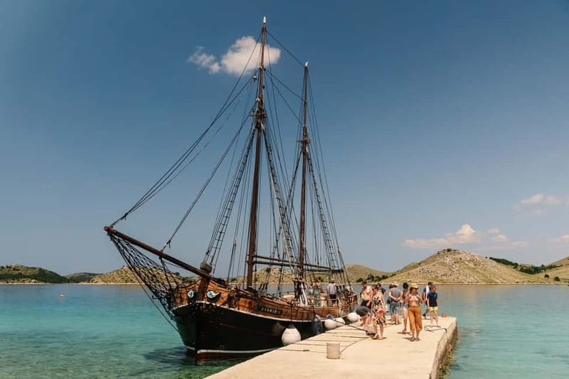 Zadar: Boat Tour with Unlimited Wine & 3 Stops - Boarding the historic wooden boat from Gostilje Boat Excursions